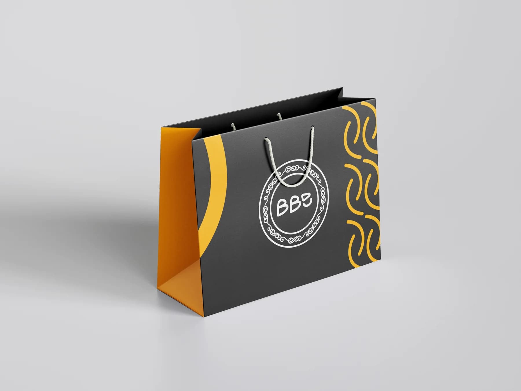 Dark shopping bag with yellow graphics and the BBE circular badge