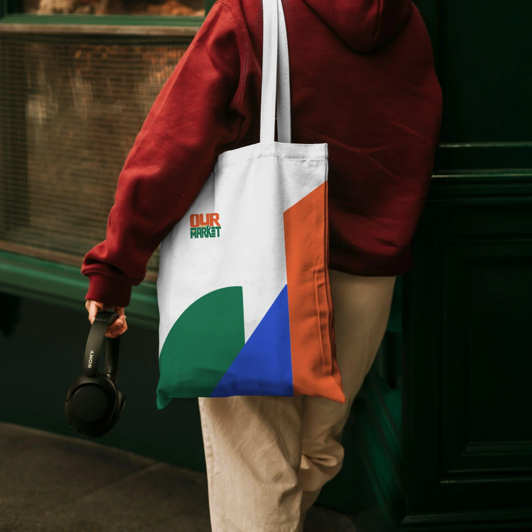 Geometric Our Market graphic in green, blue, orange and yellow on the reverse of a tote